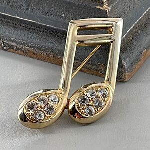 Allison Reed musical note brooch with rhinestone decor